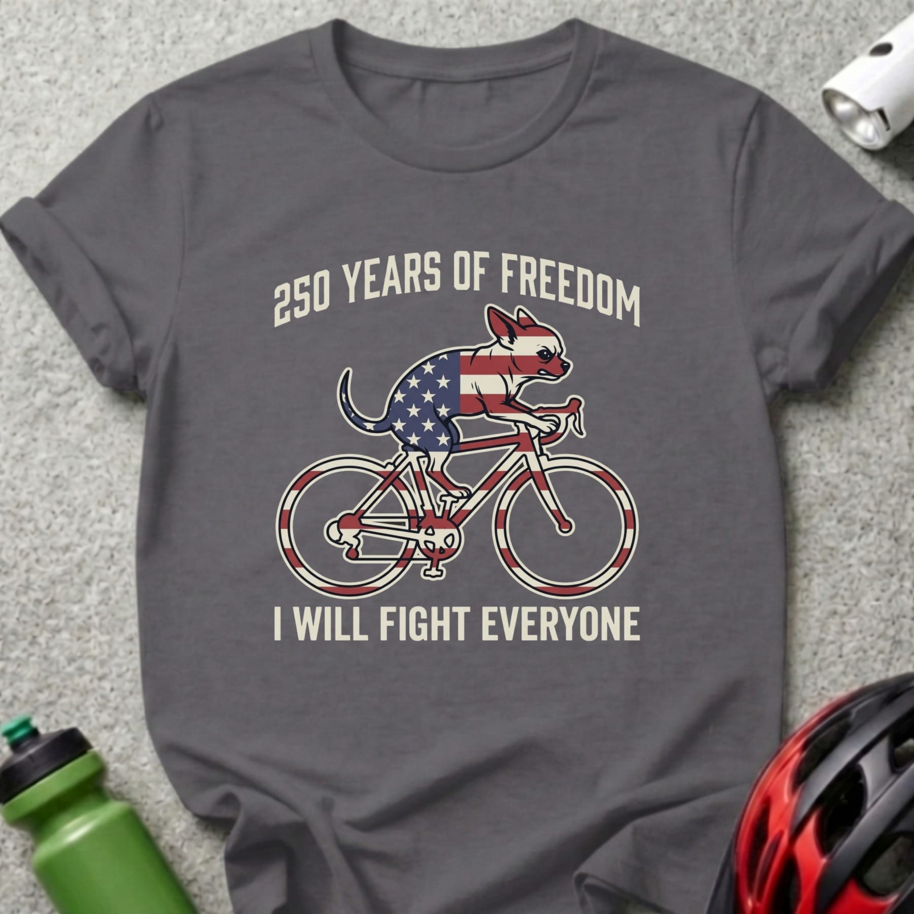 Dark gray t-shirt with patriotic dog riding bicycle graphic and text.