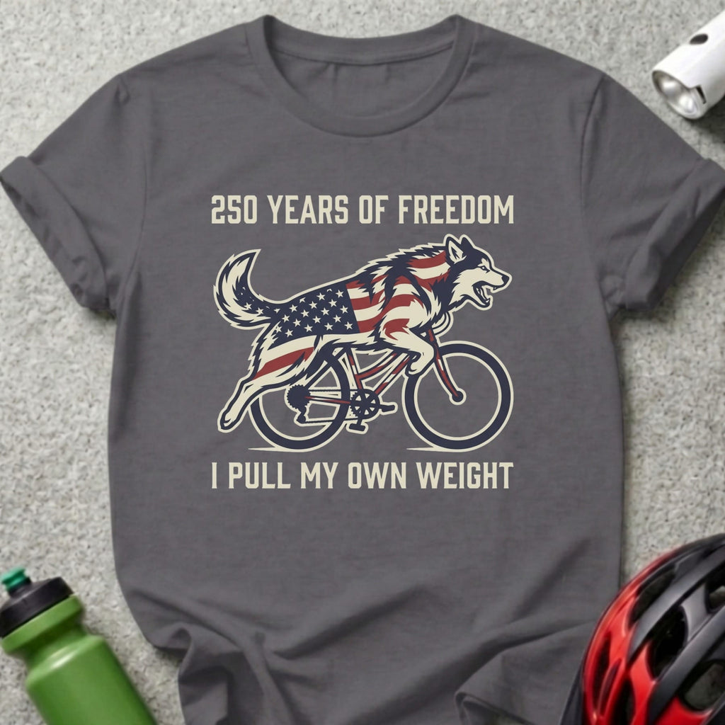 Wolf on bicycle with American flag design, text "250 YEARS OF FREEDOM I PULL MY OWN WEIGHT".