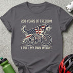 Wolf on bicycle with American flag design, text "250 YEARS OF FREEDOM I PULL MY OWN WEIGHT".
