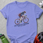 Purple t-shirt with cyclist design and "250 Years of Freedom Built For Speed" text.