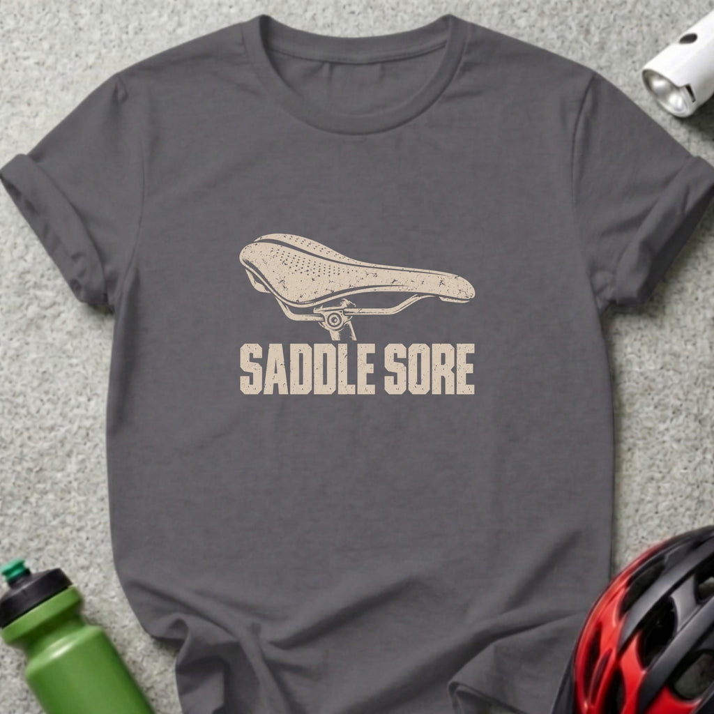 Charcoal gray t-shirt featuring a vintage bicycle saddle graphic and the text SADDLE SORE.