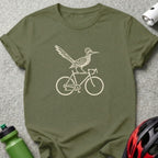 An olive green t-shirt featuring a cream-colored graphic of a roadrunner riding a bicycle.