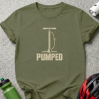 Olive green t-shirt featuring a bicycle pump illustration and the word PUMPED in distressed white lettering.