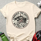 T-shirt graphic with cyclist on mountain road, "Embrace the Suffer No Easy Miles" text.