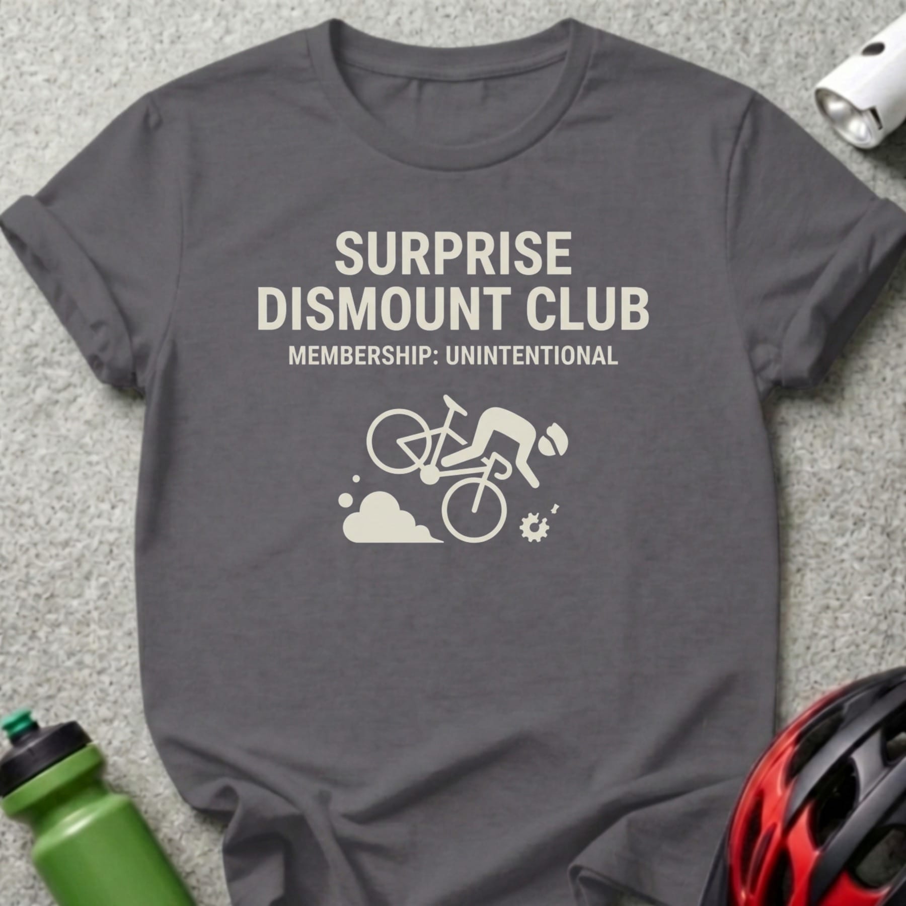 Grey t-shirt with "Surprise Dismount Club" and cyclist graphic.