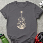 A dark gray t-shirt with a cream-colored graphic of a guitar silhouette enclosing a mountain cycling scene.