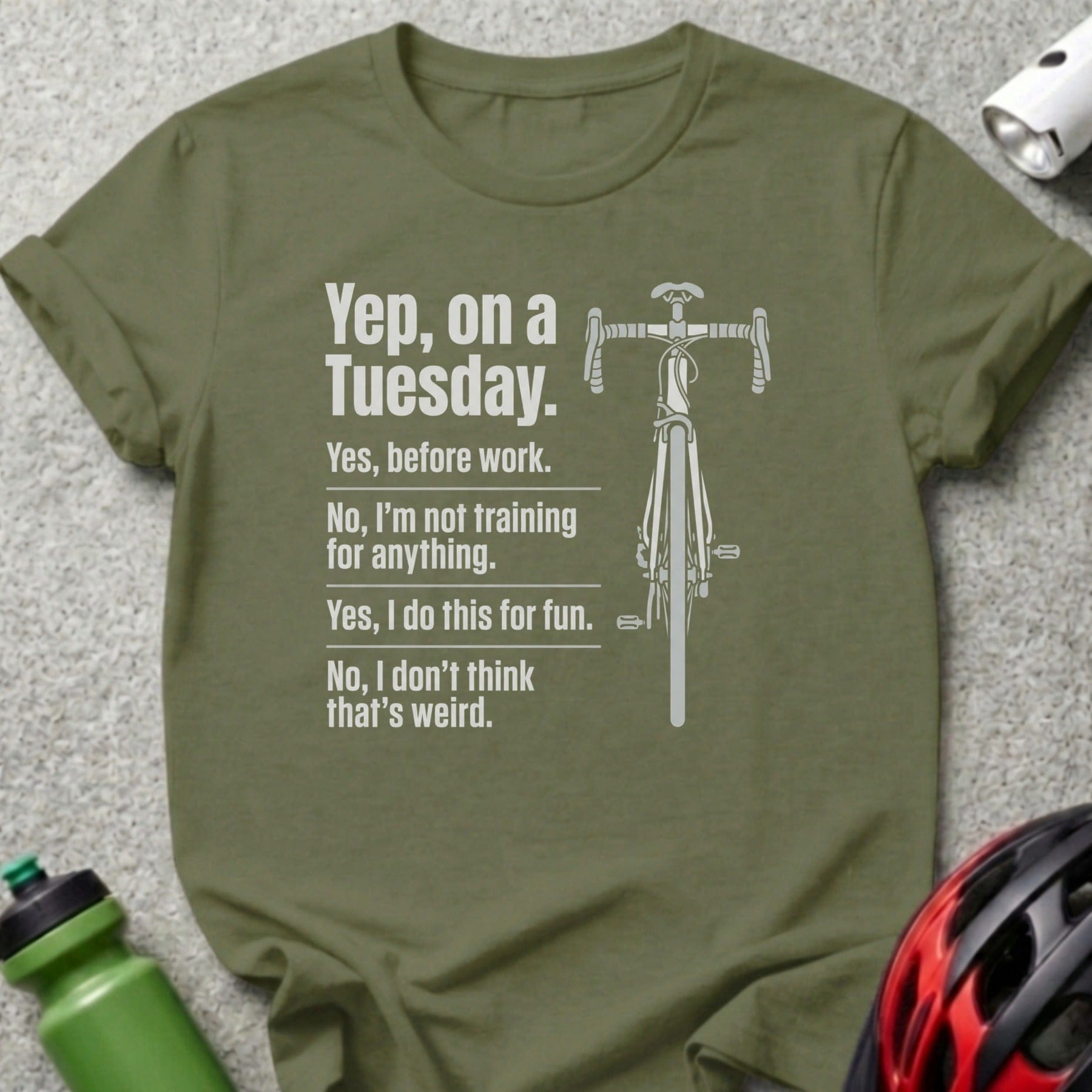 Olive green t-shirt with bicycle graphic and humorous text about cycling.