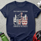 Navy t-shirt with cyclist illustration, "250 Years of Freedom" and "Powered by the Streets".