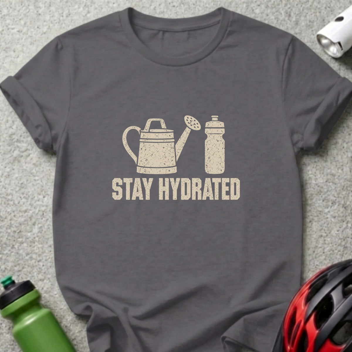A dark gray crewneck t-shirt featuring a distressed graphic of a watering can and a water bottle, with the text "STAY HYDRATED" below.
