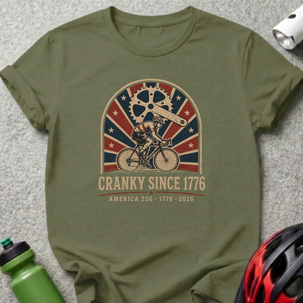 Olive green t-shirt with "CRANKY SINCE 1776 AMERICA 250 - 1776 - 2026" text.