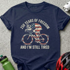 Navy t-shirt with cyclist graphic and text "250 Years of Freedom and I'm Still Tired".