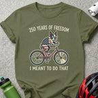 French bulldog on bicycle with American flag, reads "250 YEARS OF FREEDOM I MEANT TO DO THAT".