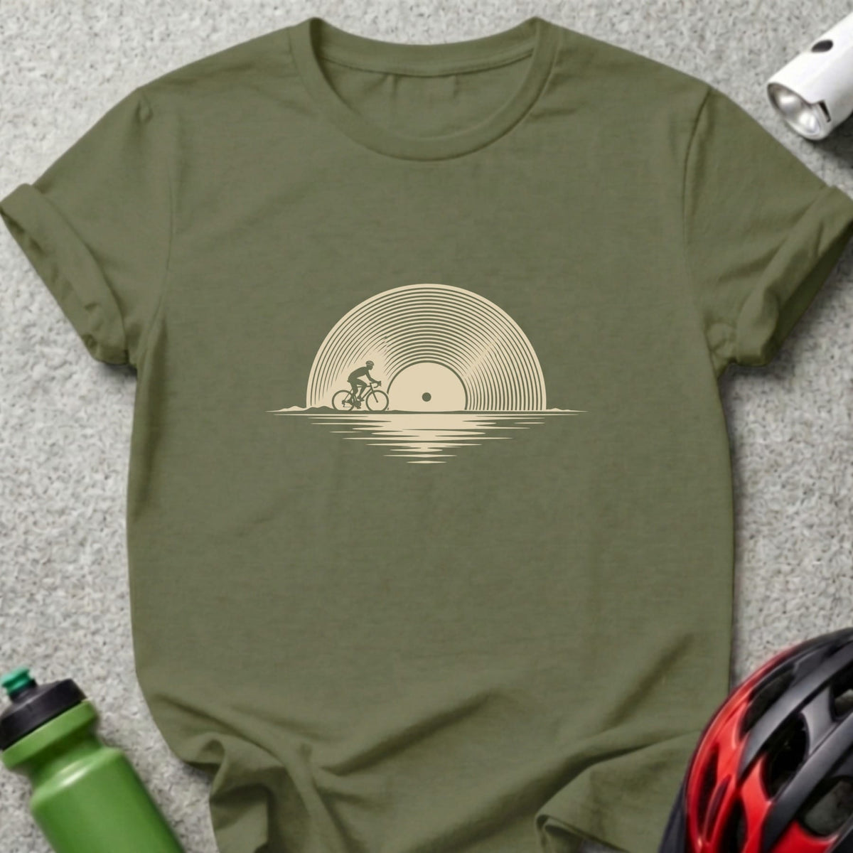Olive green crewneck t-shirt featuring a beige graphic of a cyclist riding past a vinyl record sun.