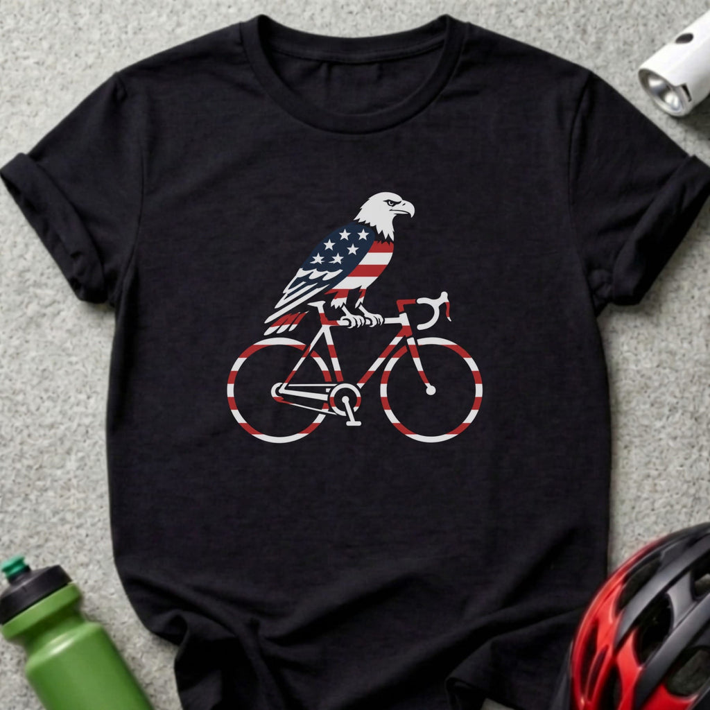 Black t-shirt with an eagle riding a bicycle, featuring American flag pattern.