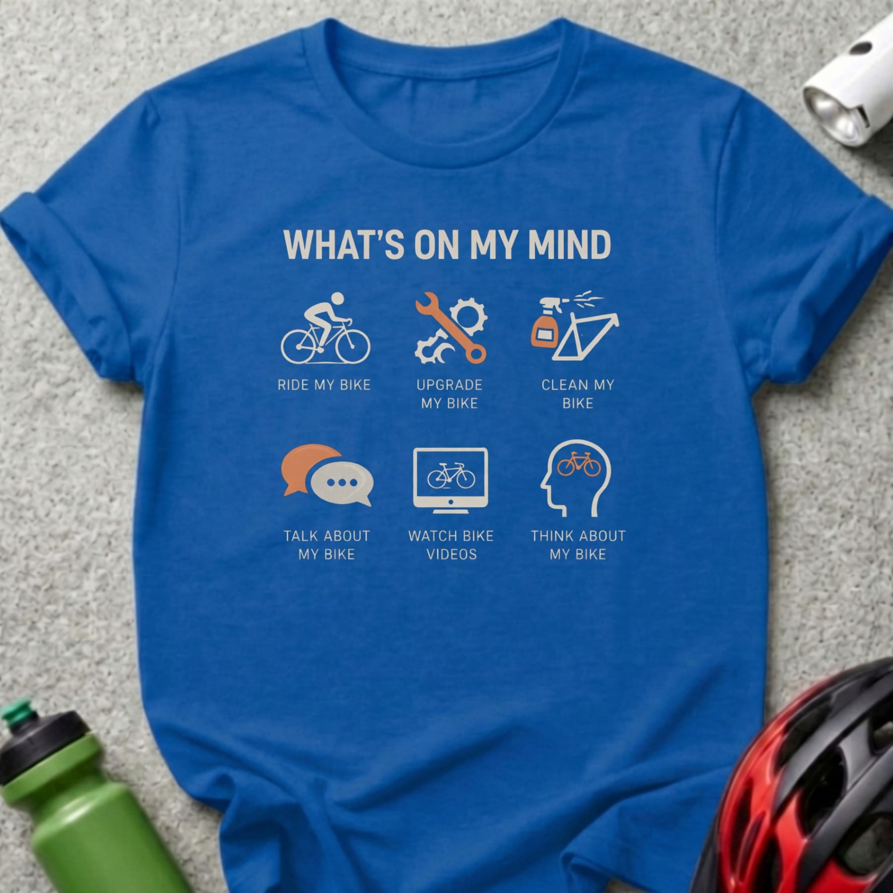 Blue t-shirt with "What's on my mind" text and bicycle related icons.