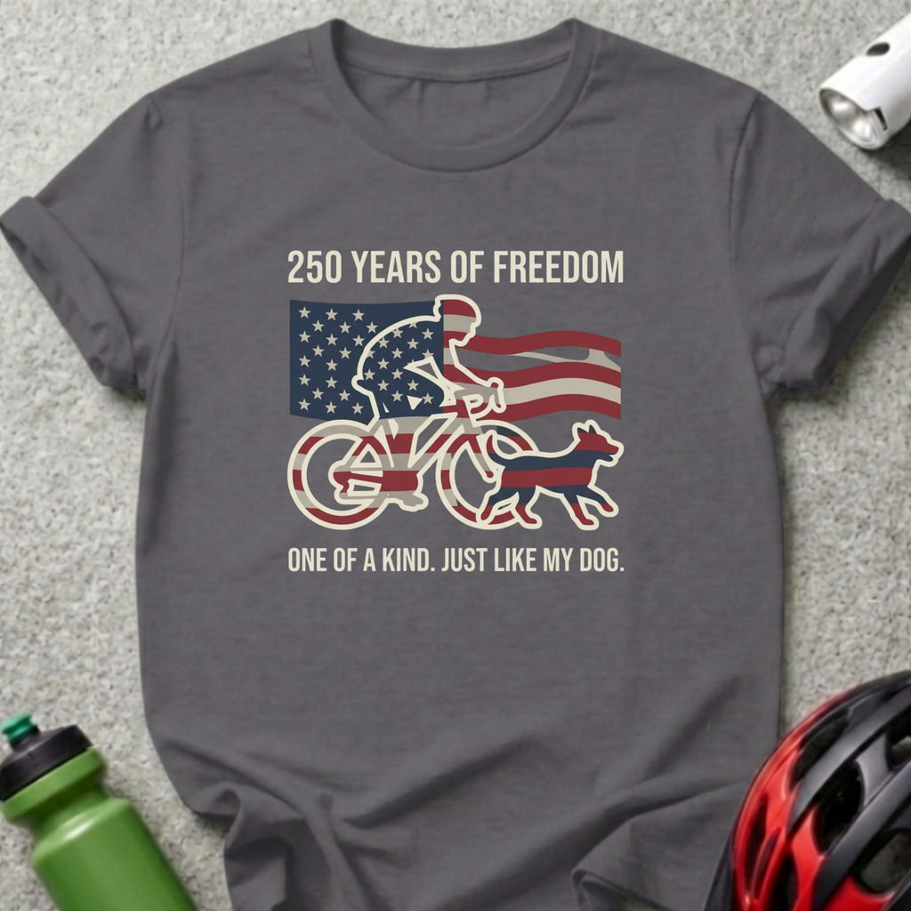Dark grey t-shirt with a cyclist and dog design, featuring American flag elements and text.