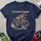 Dog wearing American flag bandana rides bicycle, "250 Years of Freedom, I Fear Nothing."