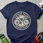 Navy t-shirt with circular "Vintage Frame Modern Engine" bicycle graphic.