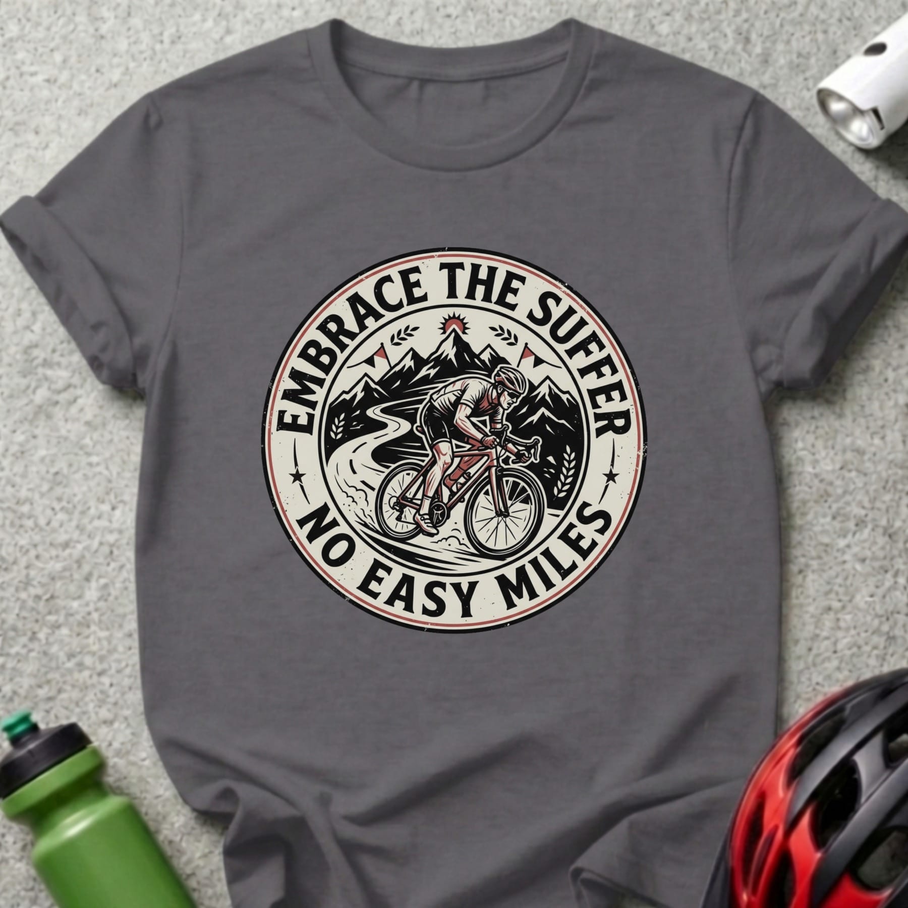 Cyclist in mountains on dark grey t-shirt with "Embrace the Suffer No Easy Miles" text.