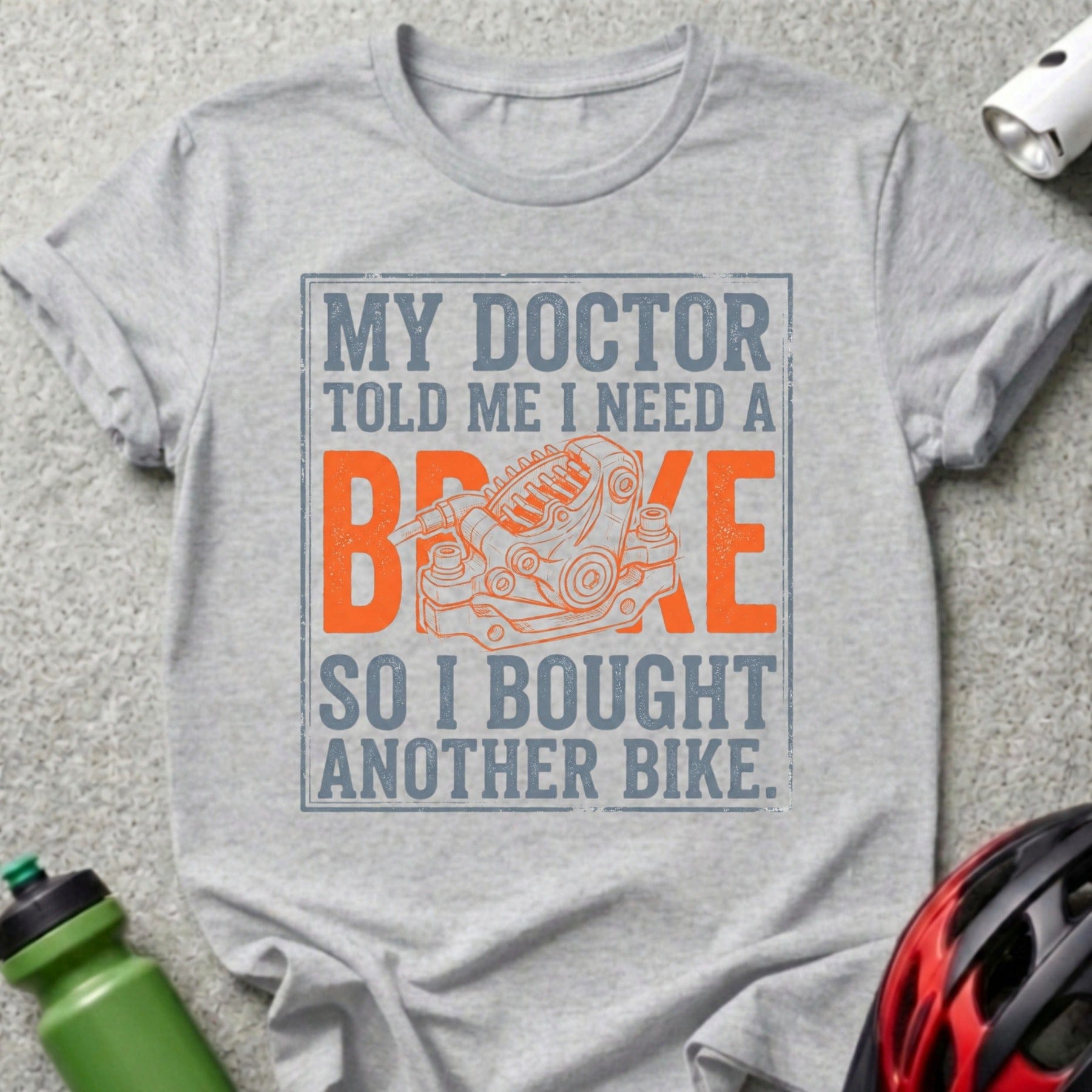 Grey t-shirt with "My doctor told me I need a brake so I bought another bike" and bicycle brake illustration.
