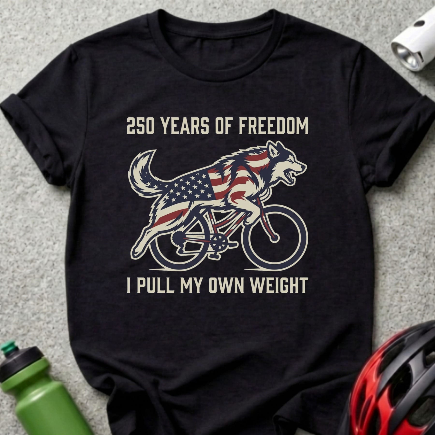 Wolf on a bicycle with American flag design and text "250 Years of Freedom I Pull My Own Weight".