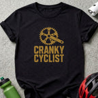 Black t-shirt with gold distressed graphic of a bike crank and "CRANKY CYCLIST" text.