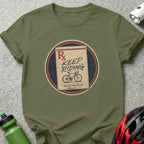 Green t-shirt with a circular graphic of a prescription pad saying "Keep Riding" and a bicycle.