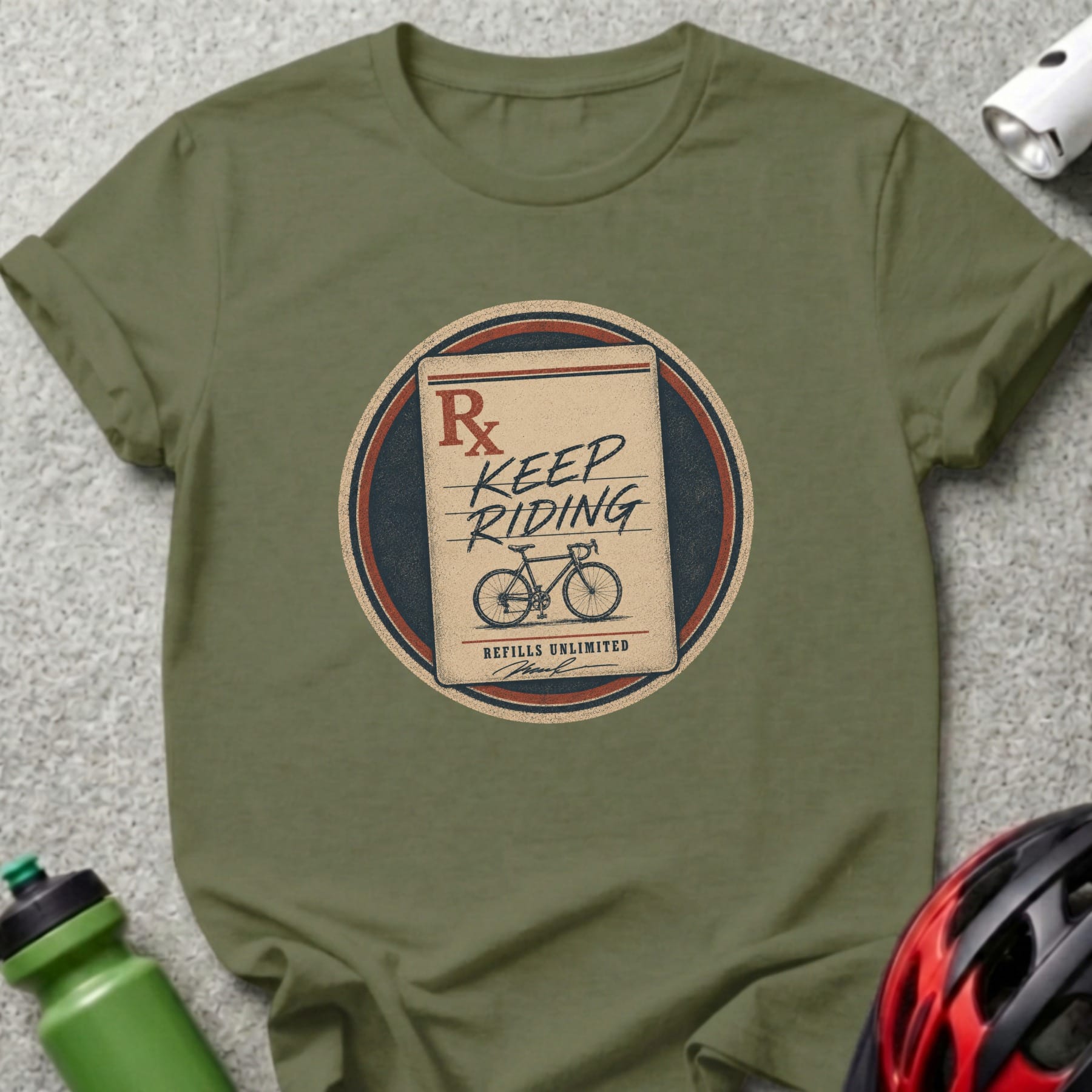 Green t-shirt with a circular graphic of a prescription pad saying "Keep Riding" and a bicycle.