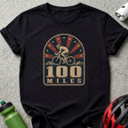 Black t-shirt with vintage design: cyclist, mountains, and "100 MILES".