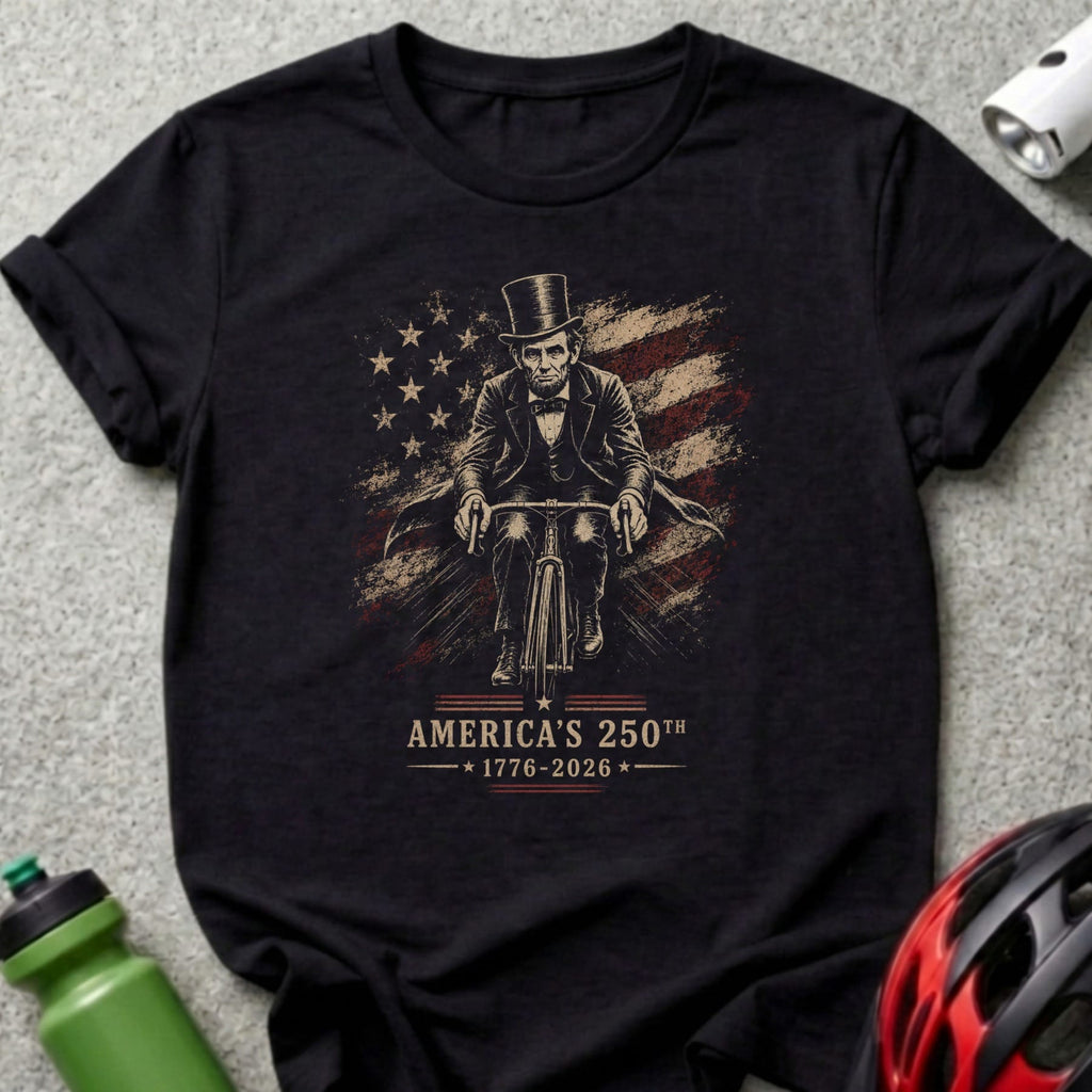 Abraham Lincoln on a bicycle with American flag and "America's 250th 1776-2026" text.