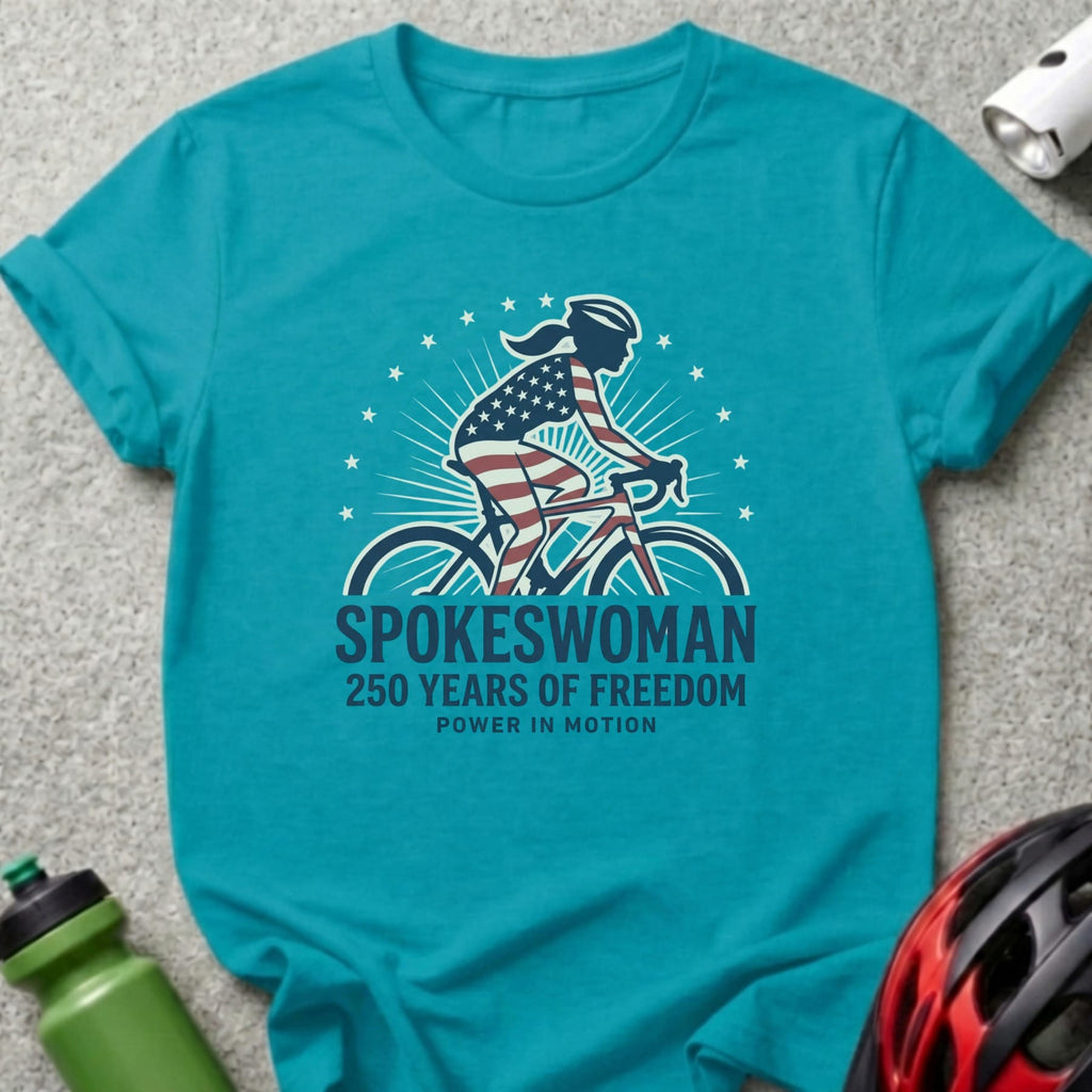 Turquoise t-shirt with "SPOKESWOMAN 250 YEARS OF FREEDOM" text and cyclist graphic.