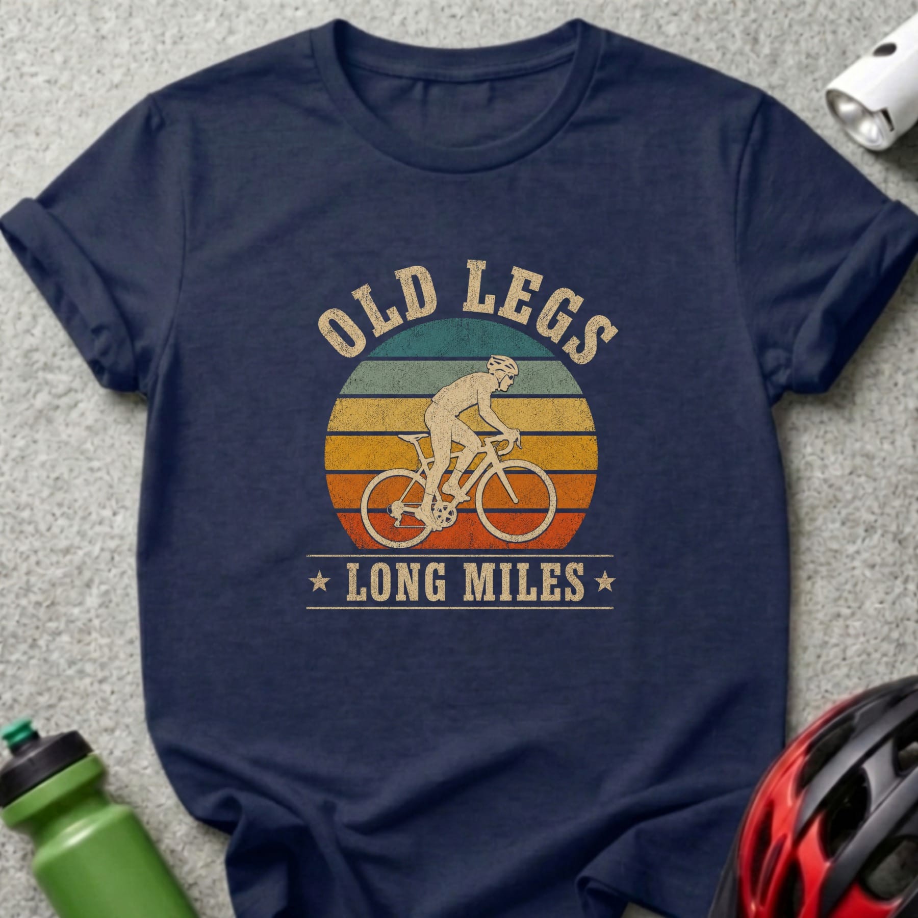 Navy t-shirt with cyclist graphic and text "OLD LEGS LONG MILES".