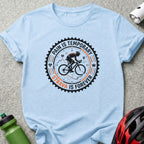 Light blue t-shirt with black and orange "STRAVA IS FOREVER" cycling graphic.