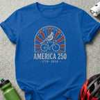 Blue t-shirt with "AMERICA 250 1776-2026" text and a cardinal on a bicycle.