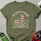 Olive green t-shirt with "250 Years of Freedom" and cyclists graphic.